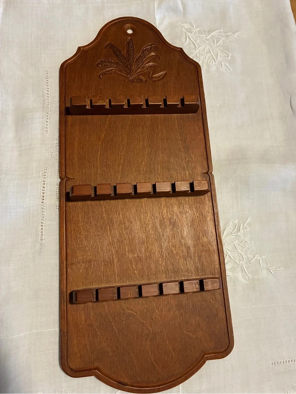 Vintage wood spoon holder with wheat design at the too.